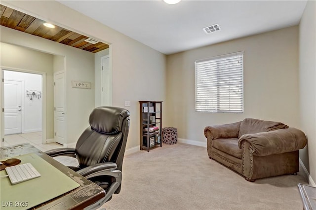 home office featuring visible vents, baseboards, and light carpet