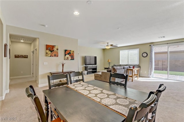 dining area with baseboards, light colored carpet, ceiling fan, and visible vents