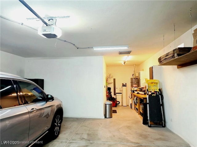 garage with water heater and a garage door opener