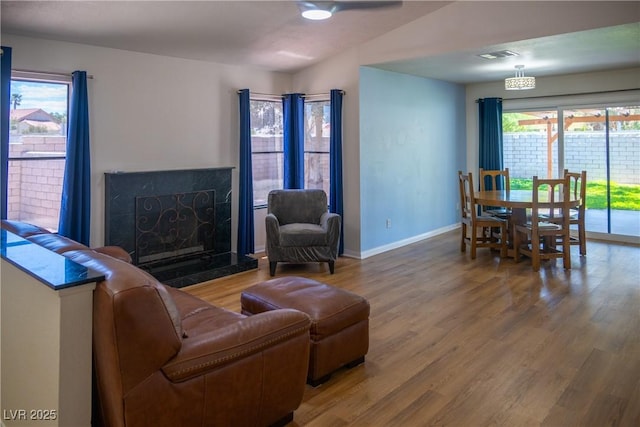 living area featuring plenty of natural light, wood finished floors, and visible vents