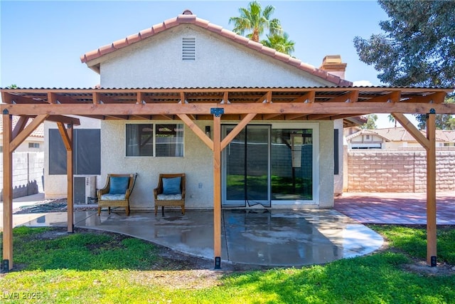 back of property with a patio, fence, a chimney, and stucco siding