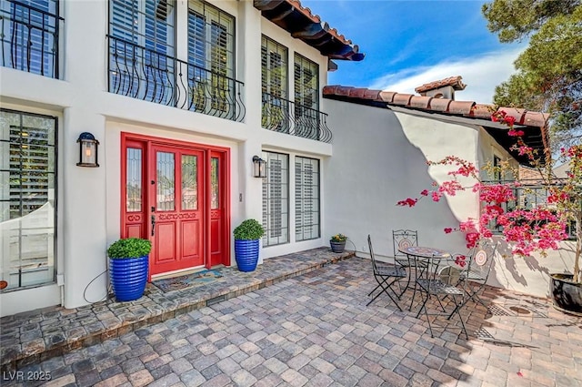 3151 Coachlight Cir, Las Vegas, NV 89117 - view of exterior entry featuring a patio and stucco siding