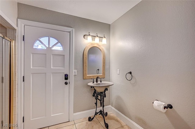 3151 Coachlight Cir, Las Vegas, NV 89117 - entryway with baseboards, a textured wall, and light tile patterned floors