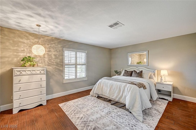 3151 Coachlight Cir, Las Vegas, NV 89117 - bedroom featuring baseboards, visible vents, and wood finished floors