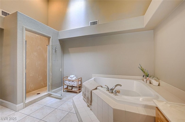 3151 Coachlight Cir, Las Vegas, NV 89117 - full bathroom with tile patterned floors, visible vents, a shower stall, and a garden tub