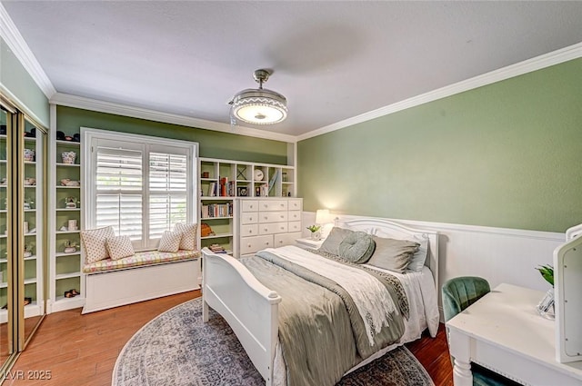3151 Coachlight Cir, Las Vegas, NV 89117 - bedroom featuring crown molding, a wainscoted wall, and wood finished floors