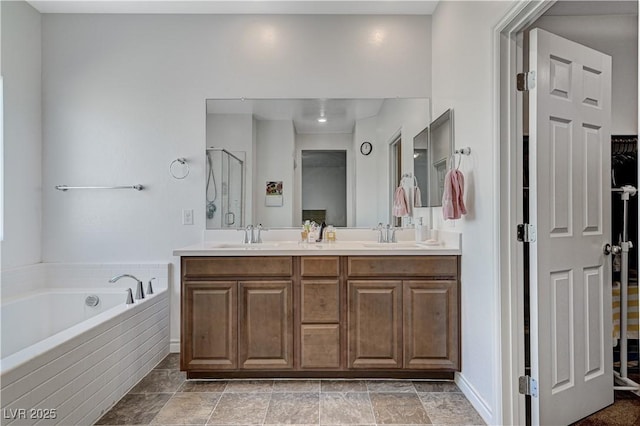 full bathroom featuring a garden tub, a sink, double vanity, and a shower stall