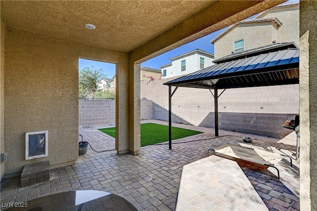 view of patio / terrace with a fenced backyard and a gazebo