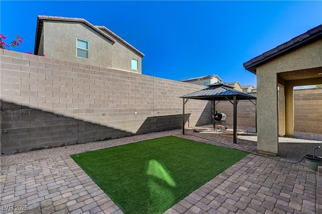view of yard with a patio, a gazebo, and a fenced backyard