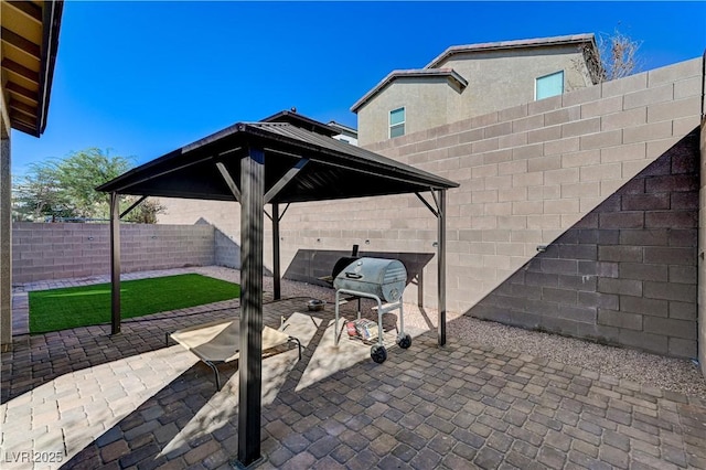 view of patio with a fenced backyard, a gazebo, and a grill