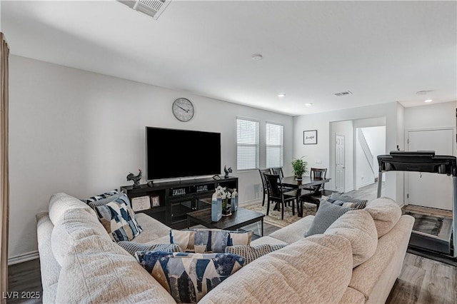 living area with baseboards, recessed lighting, wood finished floors, and visible vents