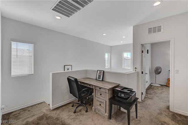 office area with a wealth of natural light, light carpet, and visible vents