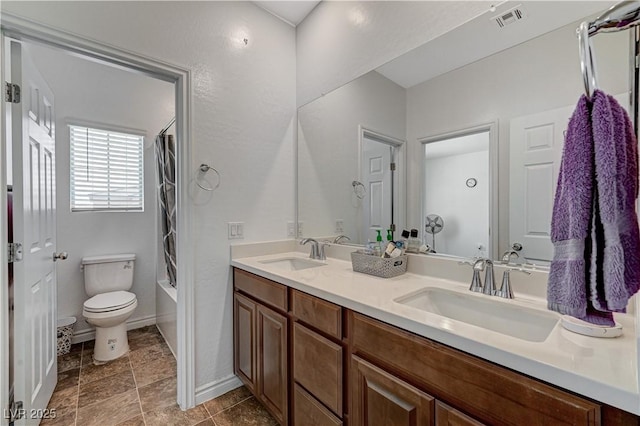 full bathroom featuring visible vents, a sink, double vanity, and toilet