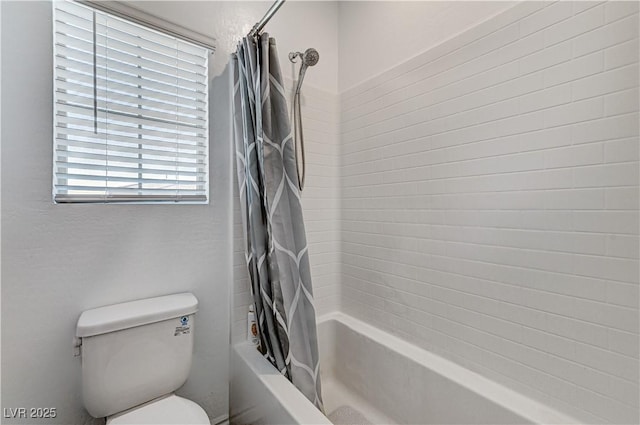 full bathroom with shower / bath combo with shower curtain and toilet
