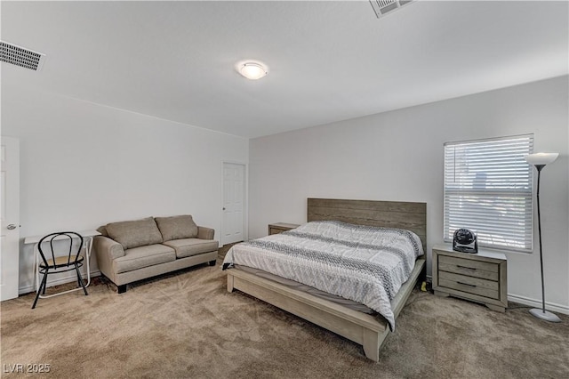bedroom with baseboards, visible vents, and carpet