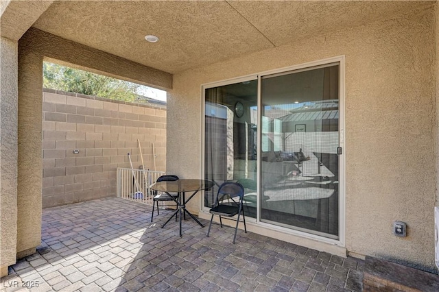 view of patio featuring fence