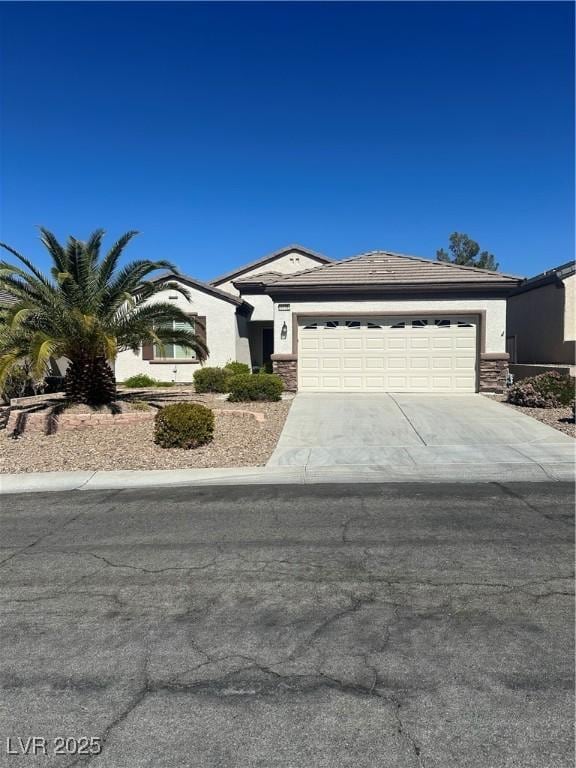 view of front facade featuring a garage, stucco siding, and concrete driveway