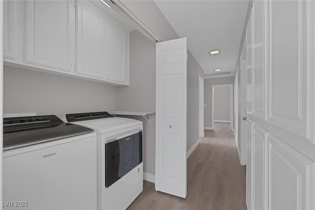 washroom with washing machine and clothes dryer, cabinet space, recessed lighting, baseboards, and dark wood-style floors
