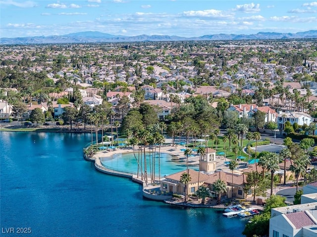 drone / aerial view featuring a residential view and a water and mountain view