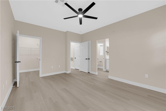 2007 Cutlass Dr Unit 0, Henderson, NV 89014 - unfurnished bedroom with visible vents, baseboards, connected bathroom, a spacious closet, and light wood-style flooring