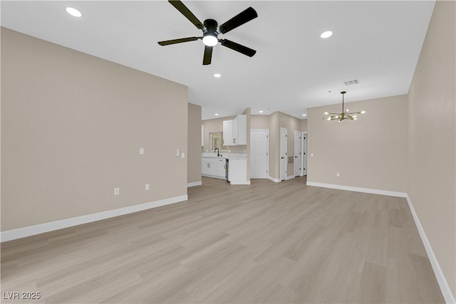 2007 Cutlass Dr Unit 0, Henderson, NV 89014 - unfurnished living room featuring light wood-style flooring, ceiling fan with notable chandelier, recessed lighting, baseboards, and visible vents