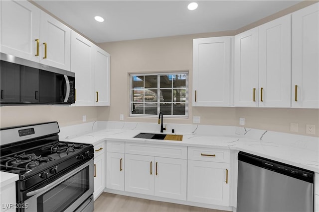 2007 Cutlass Dr Unit 0, Henderson, NV 89014 - kitchen featuring light stone counters, a sink, white cabinets, and stainless steel appliances