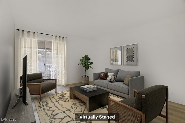 living room with baseboards and wood finished floors