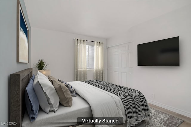bedroom with baseboards and wood finished floors