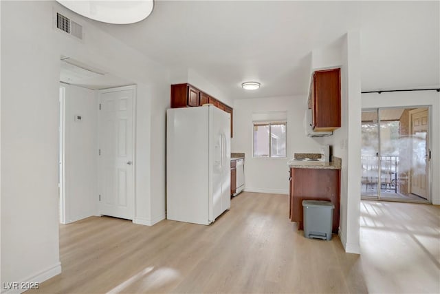kitchen featuring visible vents, white appliances, baseboards, light wood-type flooring, and light countertops