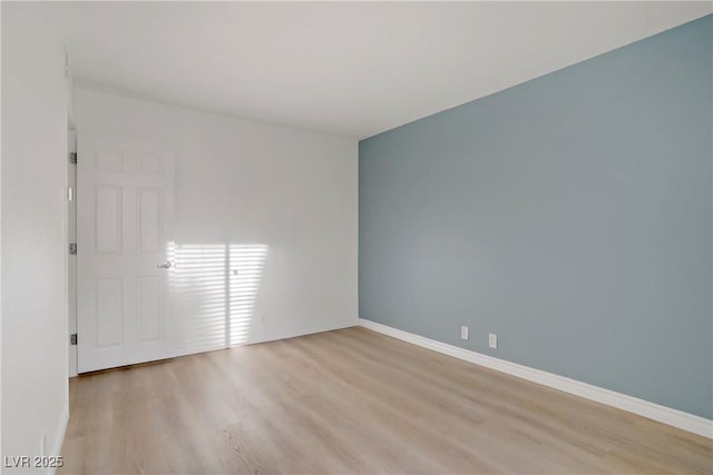 unfurnished room with light wood-style floors and baseboards