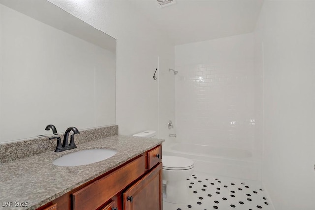 bathroom featuring vanity, toilet, and shower / tub combination