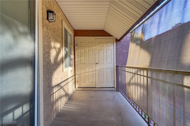 property entrance with stucco siding and a balcony