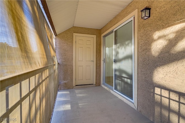 property entrance with stucco siding