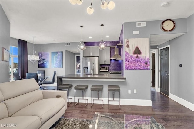 living area with baseboards, dark wood finished floors, and visible vents