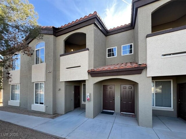 view of front of home with a tile roof and stucco siding