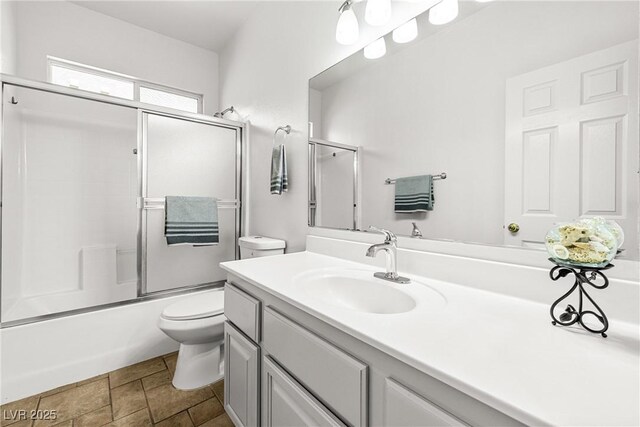 1440 Summer Glow Ave, Henderson, NV 89012 - bathroom featuring vanity, combined bath / shower with glass door, and toilet