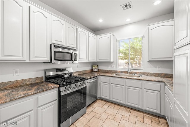 kitchen with visible vents, appliances with stainless steel finishes, a sink, white cabinets, and recessed lighting