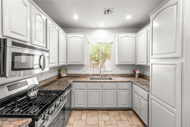 kitchen with white cabinets, a sink, stainless steel appliances, recessed lighting, and visible vents