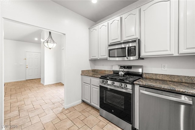 kitchen featuring white cabinets, recessed lighting, dark countertops, and appliances with stainless steel finishes