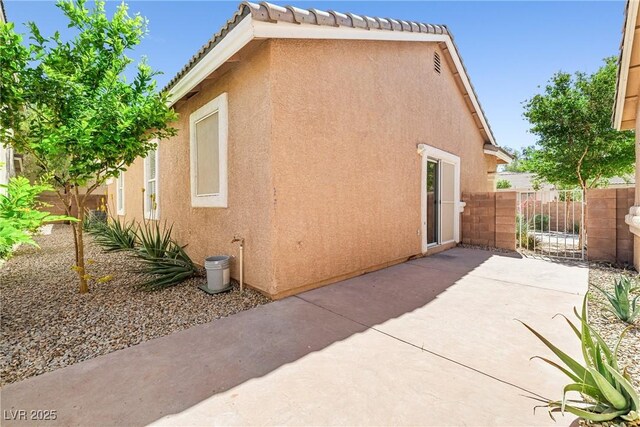 1440 Summer Glow Ave, Henderson, NV 89012 - view of side of property featuring fence, a patio area, and stucco siding