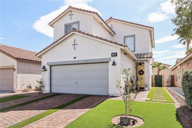 7566 Hope Valley St, Las Vegas, NV 89139 - mediterranean / spanish-style home with a garage, stucco siding, a tile roof, and decorative driveway