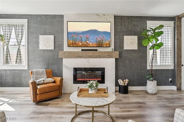 7566 Hope Valley St, Las Vegas, NV 89139 - interior space featuring baseboards, a glass covered fireplace, and wood finished floors