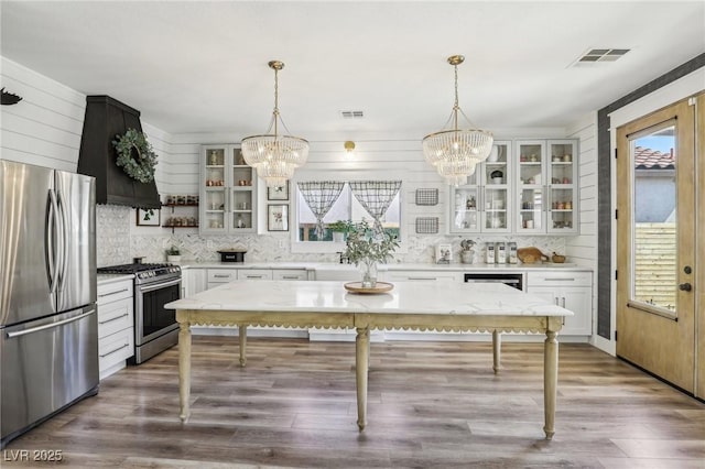 7566 Hope Valley St, Las Vegas, NV 89139 - kitchen featuring visible vents, open shelves, appliances with stainless steel finishes, and a chandelier