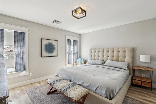 7566 Hope Valley St, Las Vegas, NV 89139 - bedroom featuring baseboards, wood finished floors, and visible vents