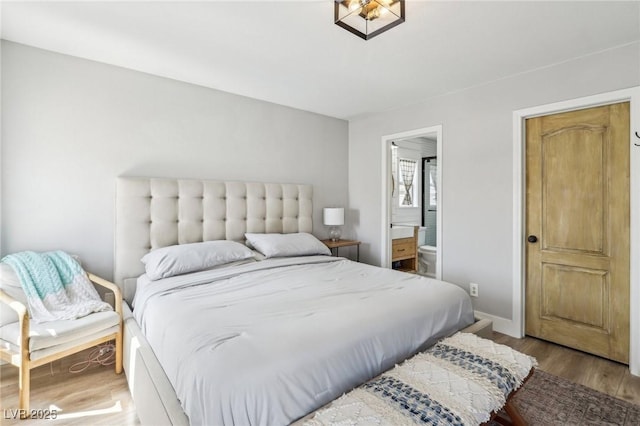 7566 Hope Valley St, Las Vegas, NV 89139 - bedroom with baseboards, ensuite bath, and wood finished floors