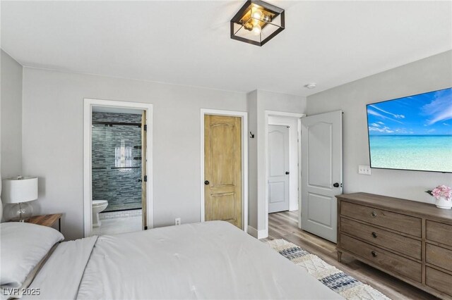 7566 Hope Valley St, Las Vegas, NV 89139 - bedroom with light wood-style flooring and connected bathroom
