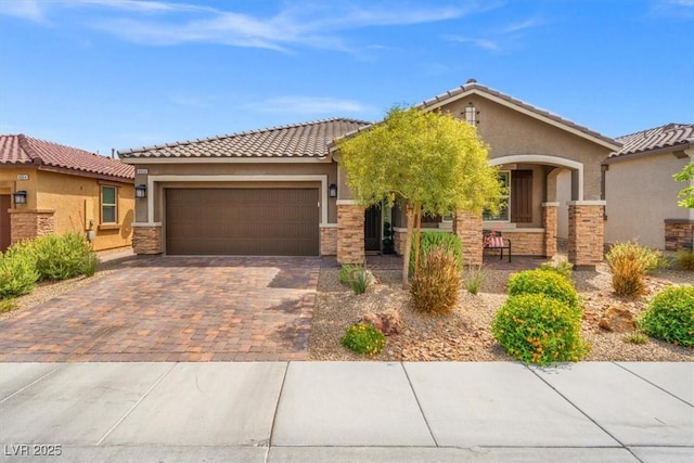 view of front facade with a garage, stucco siding, driveway, and stone siding