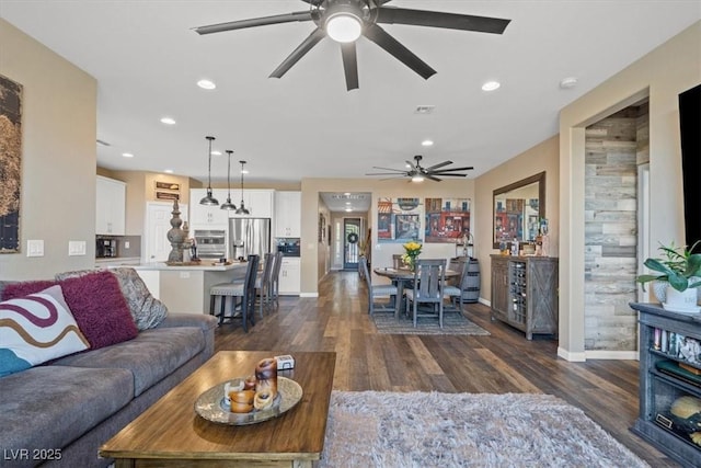 living area with recessed lighting, ceiling fan, baseboards, and dark wood-type flooring