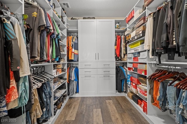 spacious closet featuring visible vents and wood finished floors