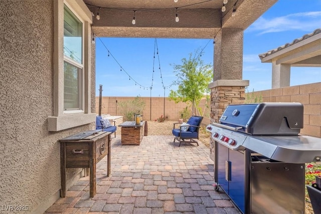 view of patio / terrace featuring a fenced backyard and a grill